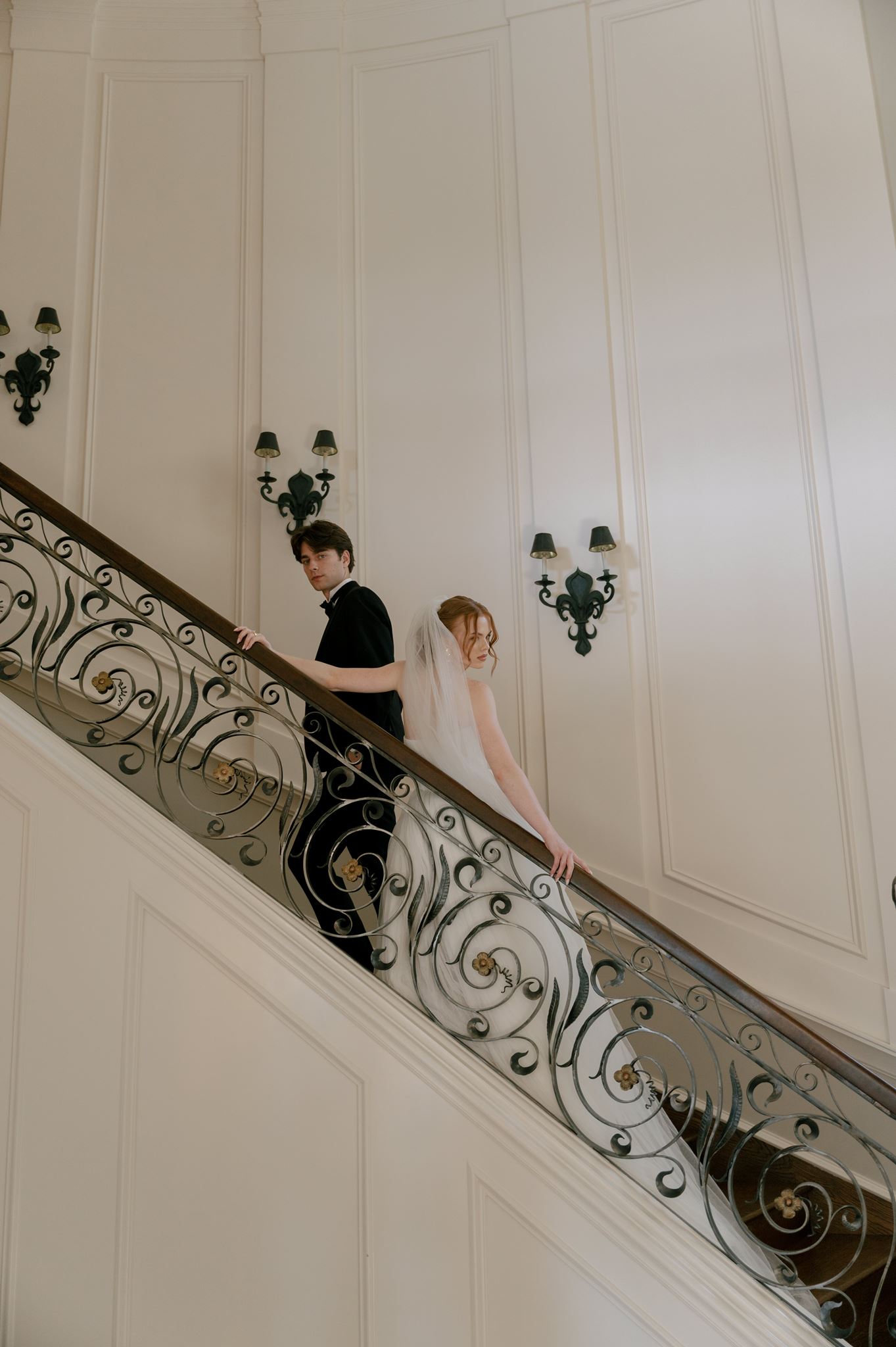 Wedding portraits on the grand staircase at the Palais de Leon wedding venue