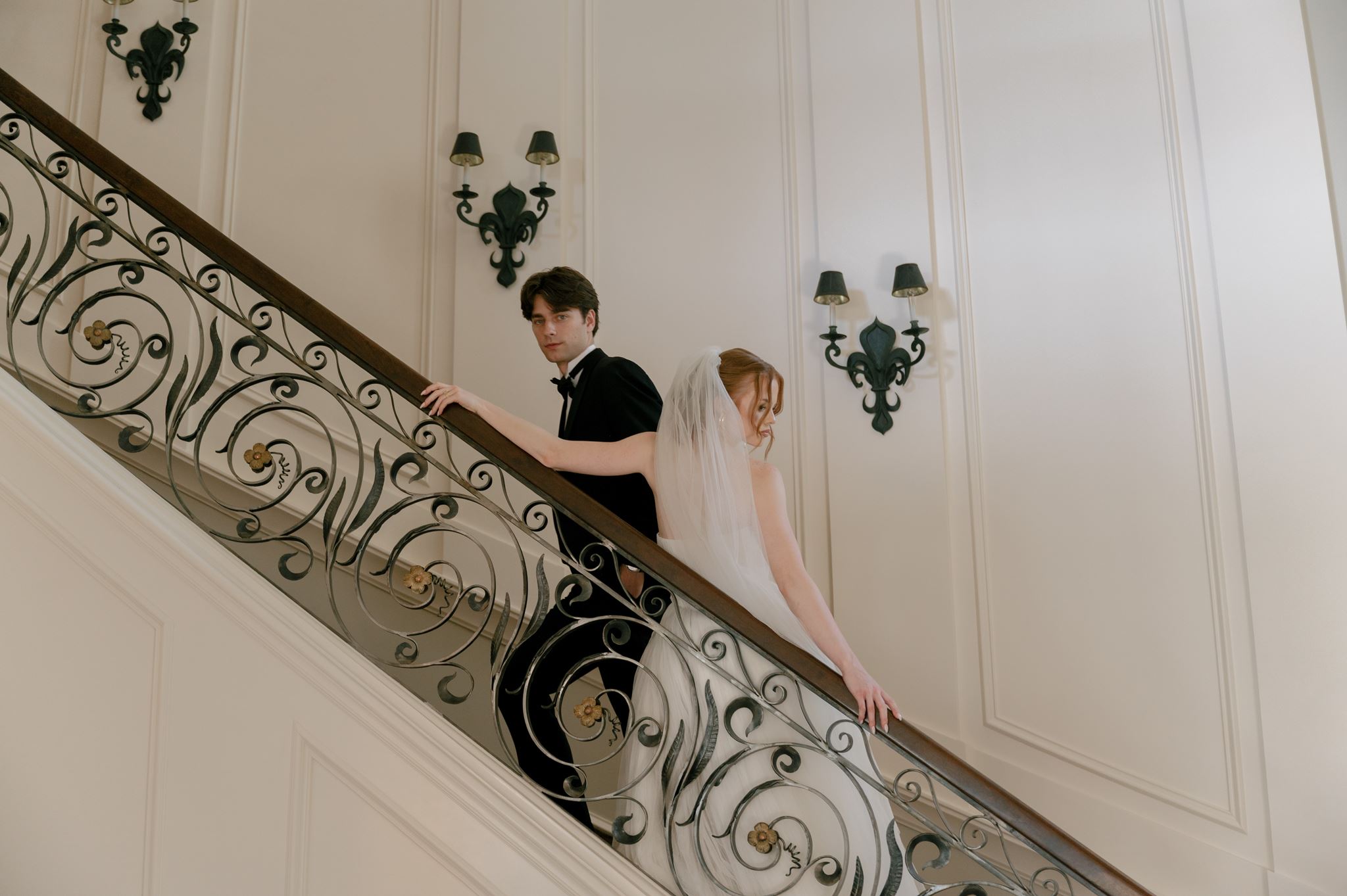 Wedding portraits on the grand staircase at the Palais de Leon wedding venue