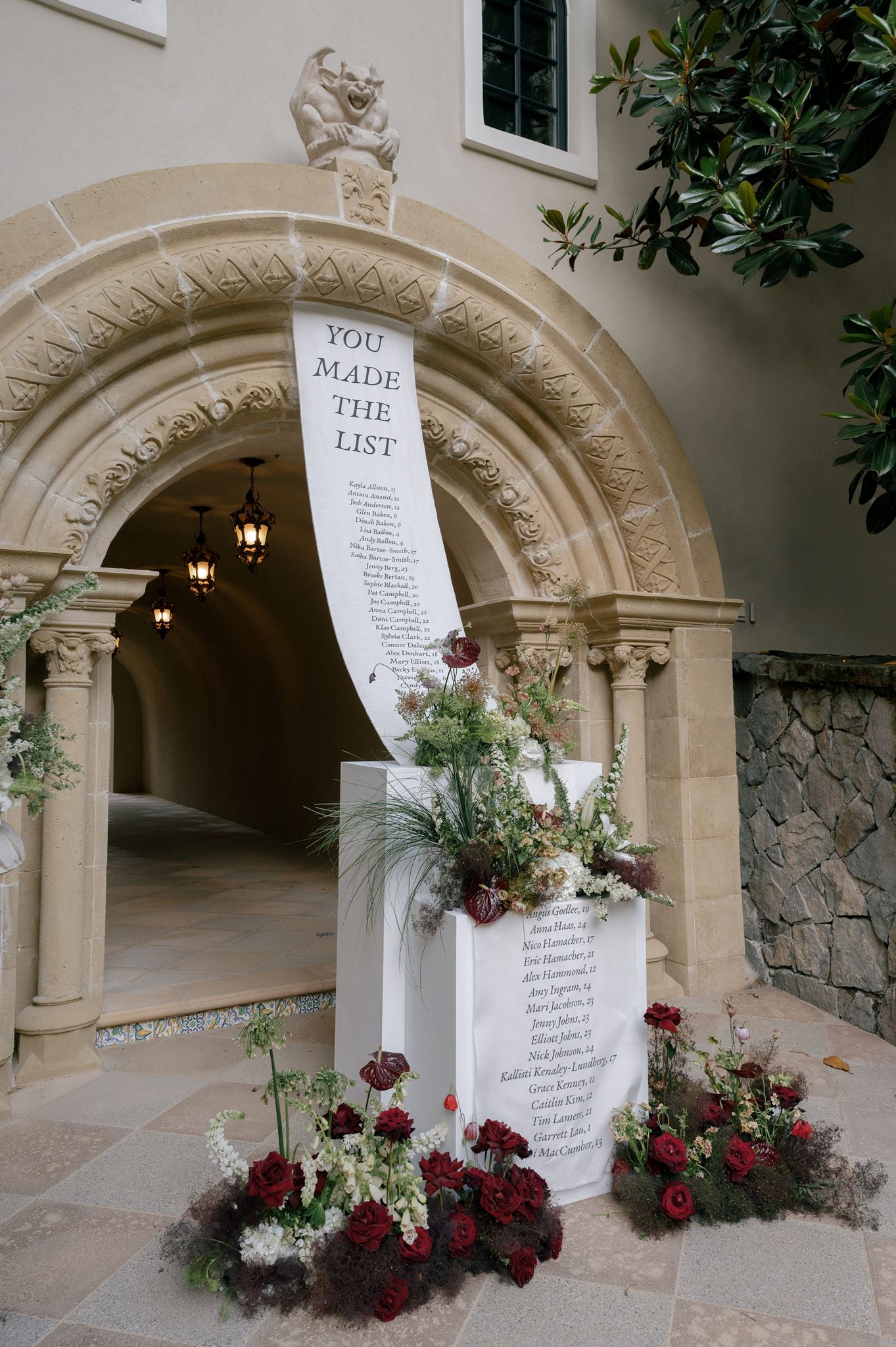 Grand linen seating chart and florals at a private estate wedding venue