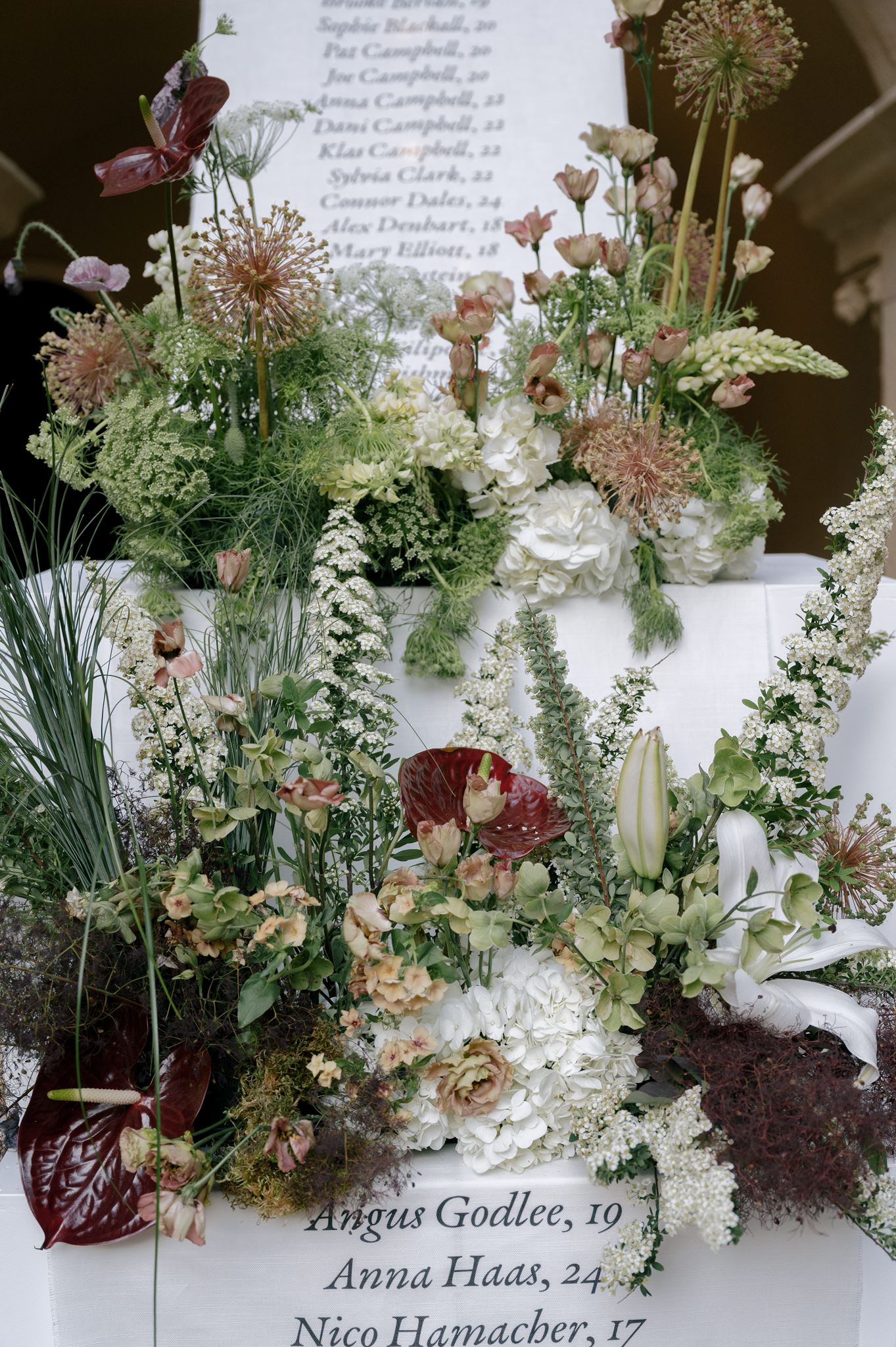 Grand linen seating chart and florals at a private estate wedding venue