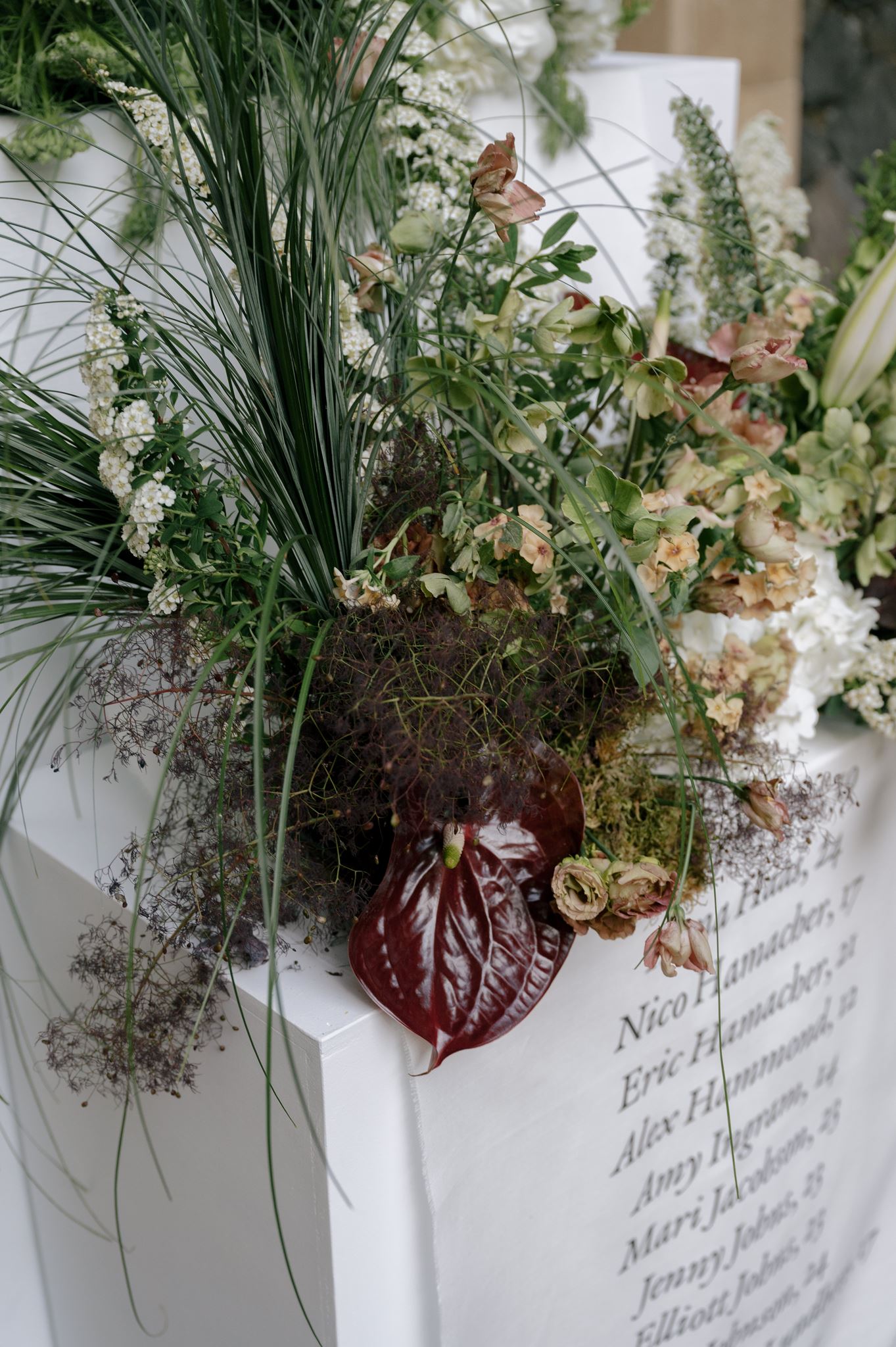 Grand linen seating chart and florals at a private estate wedding venue