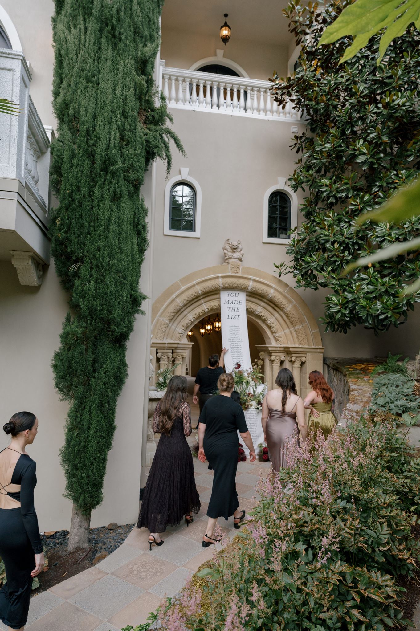 Guests using linen wedding seating chart to find their table