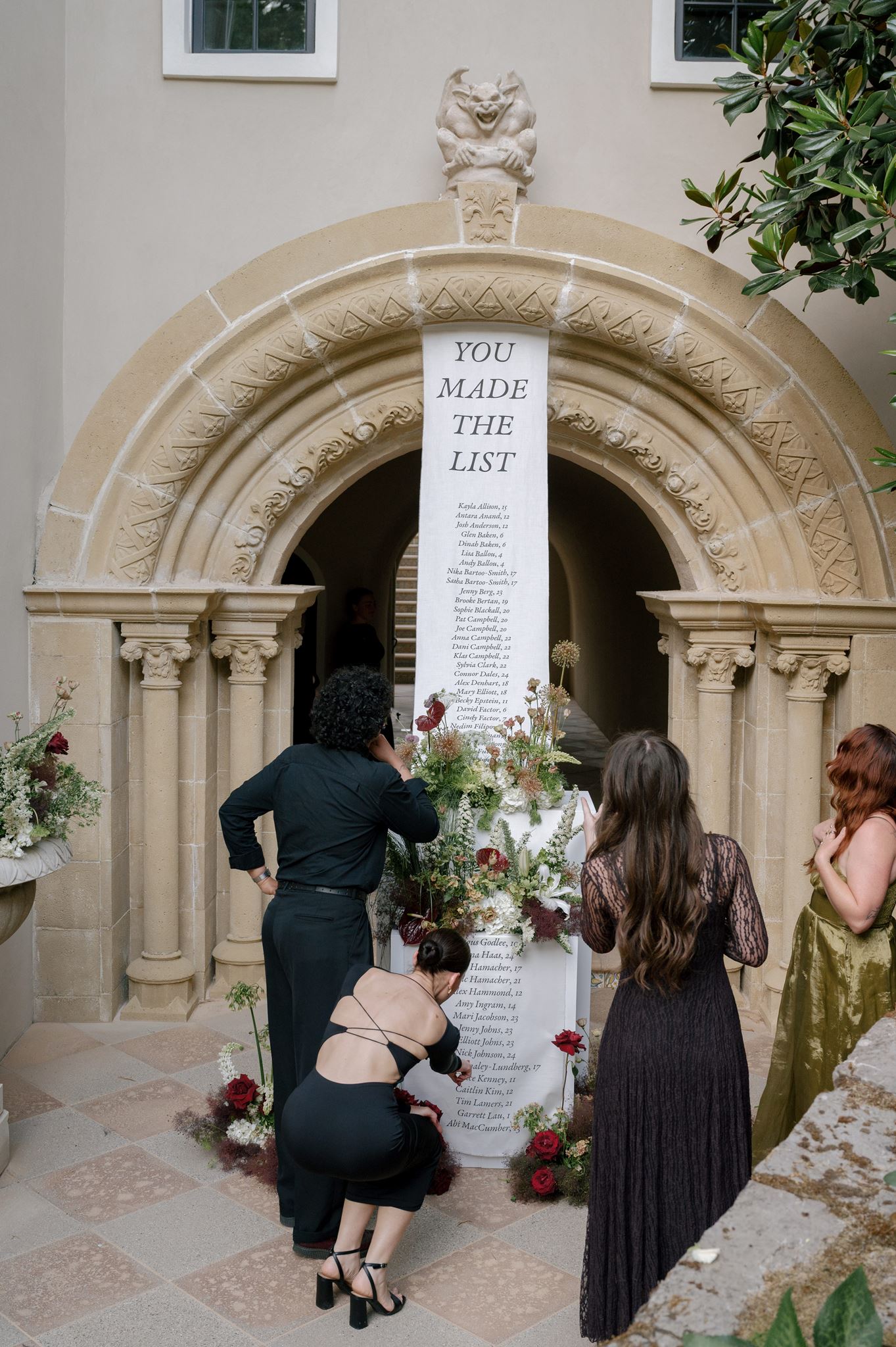 Grand linen seating chart and florals at a private estate wedding venue