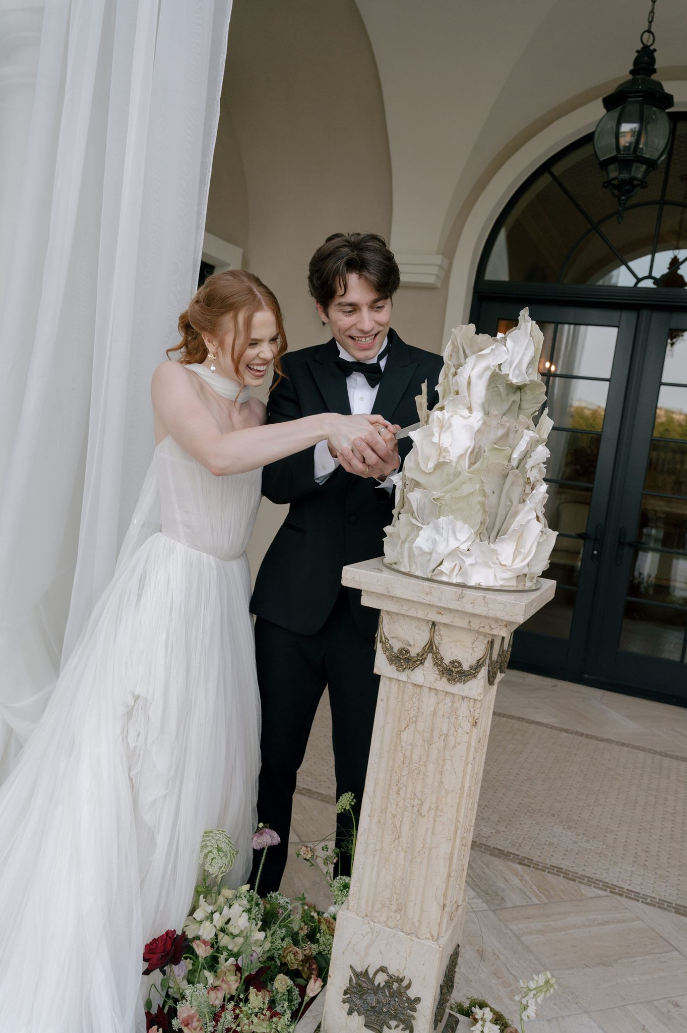 Bride and groom cutting their wedding cake