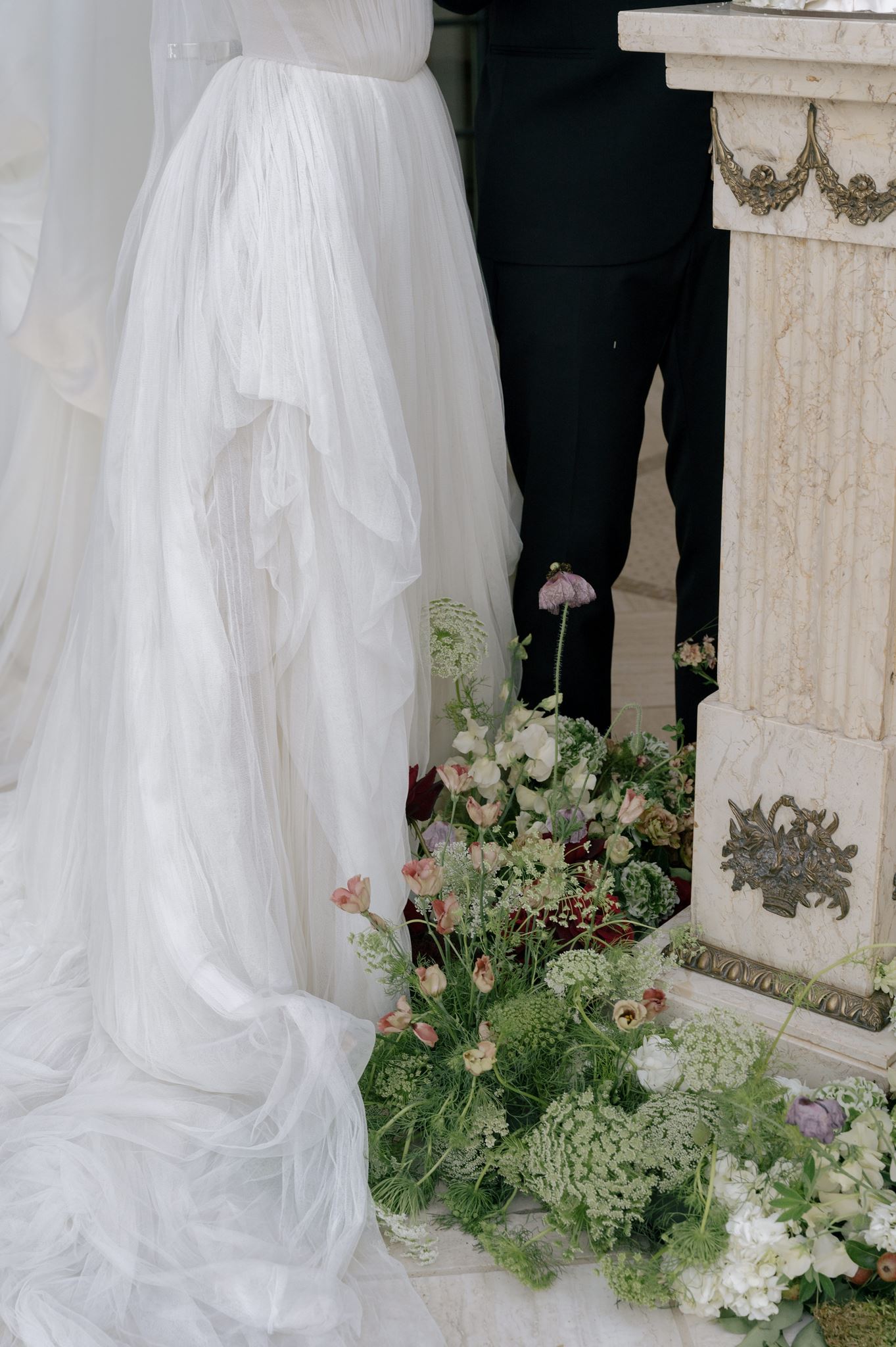Close-up of bride and groom cutting their wedding cake